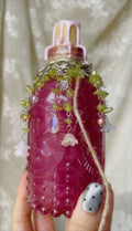 Potion display with lush forest necklace